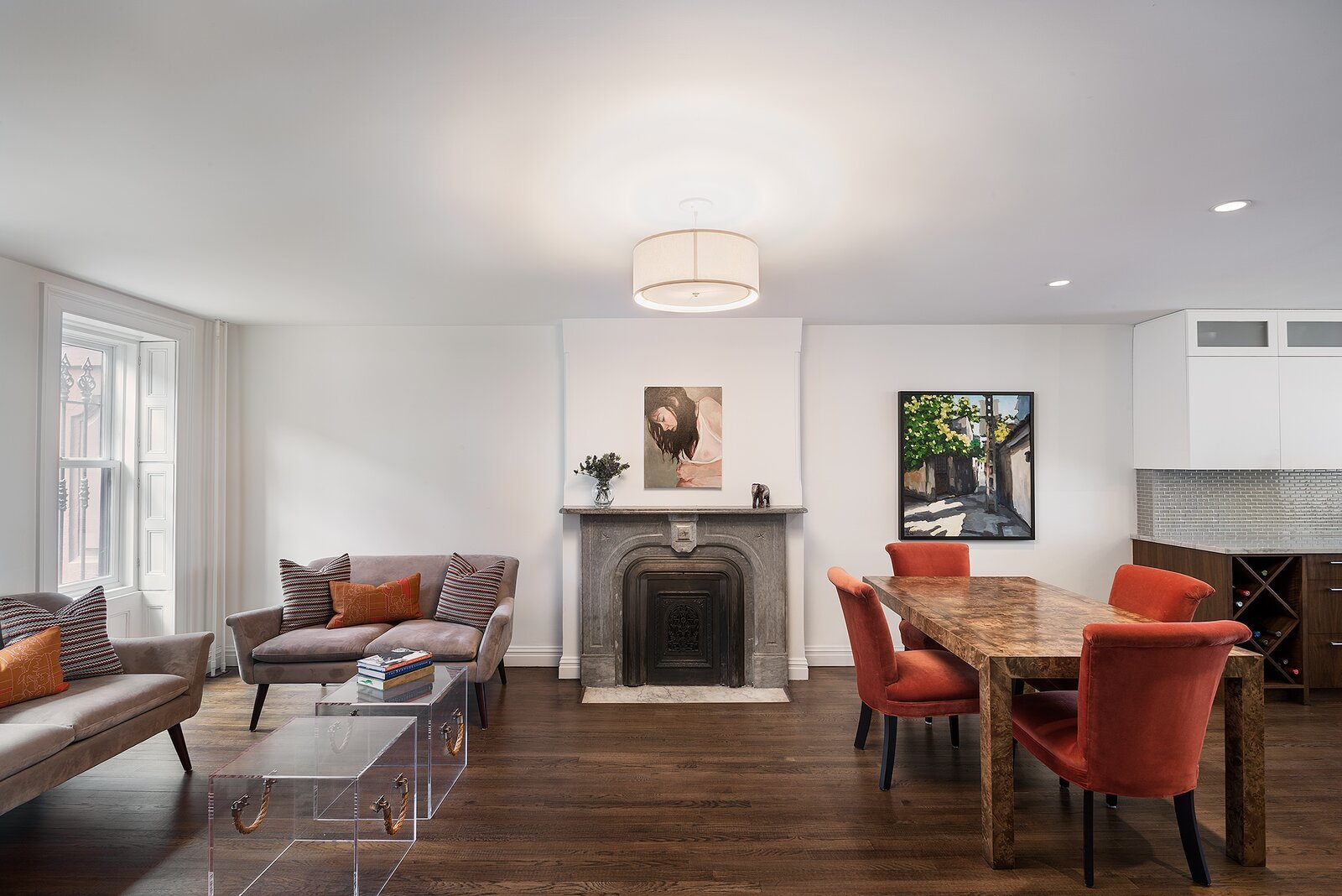 Renovated brownstone parlor floor with original fireplace and dark hardwood
