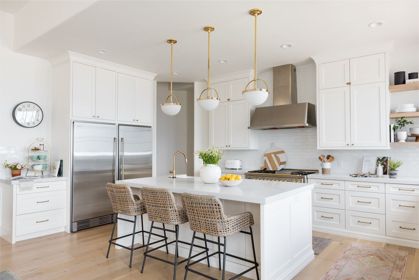 Bright renovated kitchen with brass pendants over the island