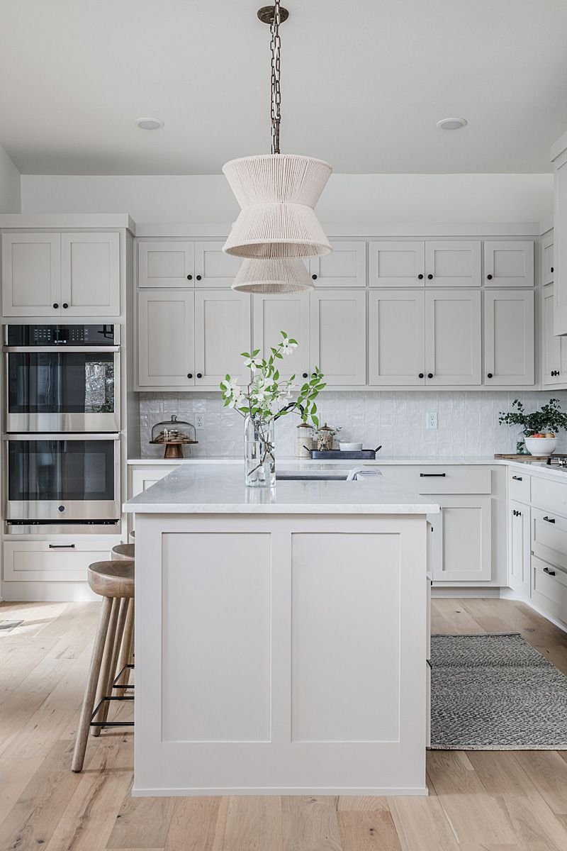 White shaker kitchen with island and tiled backsplash